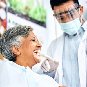 Dentist showing patient smile in reflection