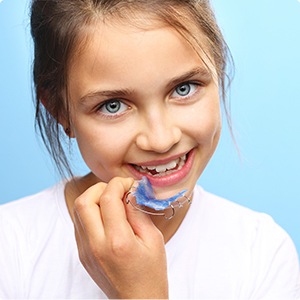 Young patient placing orthodontic appliance