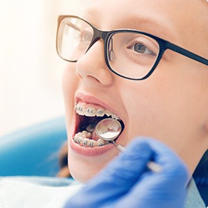 Orthodontist examining patient during dentofacial orthopedics treatment