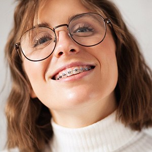 Young woman with glasses and traditional braces in Enfield, CT