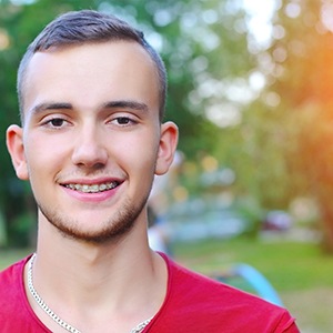 Man smiling with 3M Clarity clear ceramic brackets on teeth 
