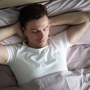 a man resting with his head elevated