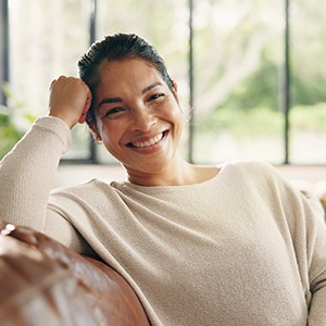 a woman smiling while on the couch